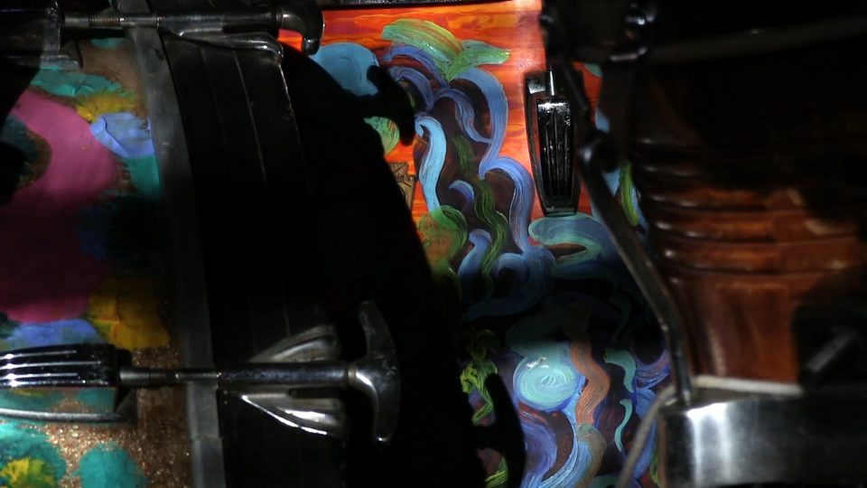 Sunlight plays across a handpainted drum set in Milford Graves's studio